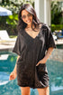 Woman wearing a black towel dress by a poolside