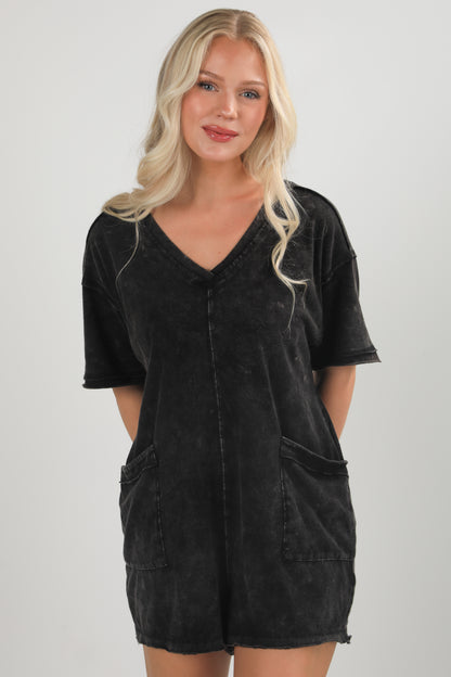 Woman wearing a black dress with a plain background