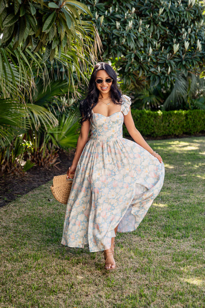 Woman in a floral dress standing in a garden