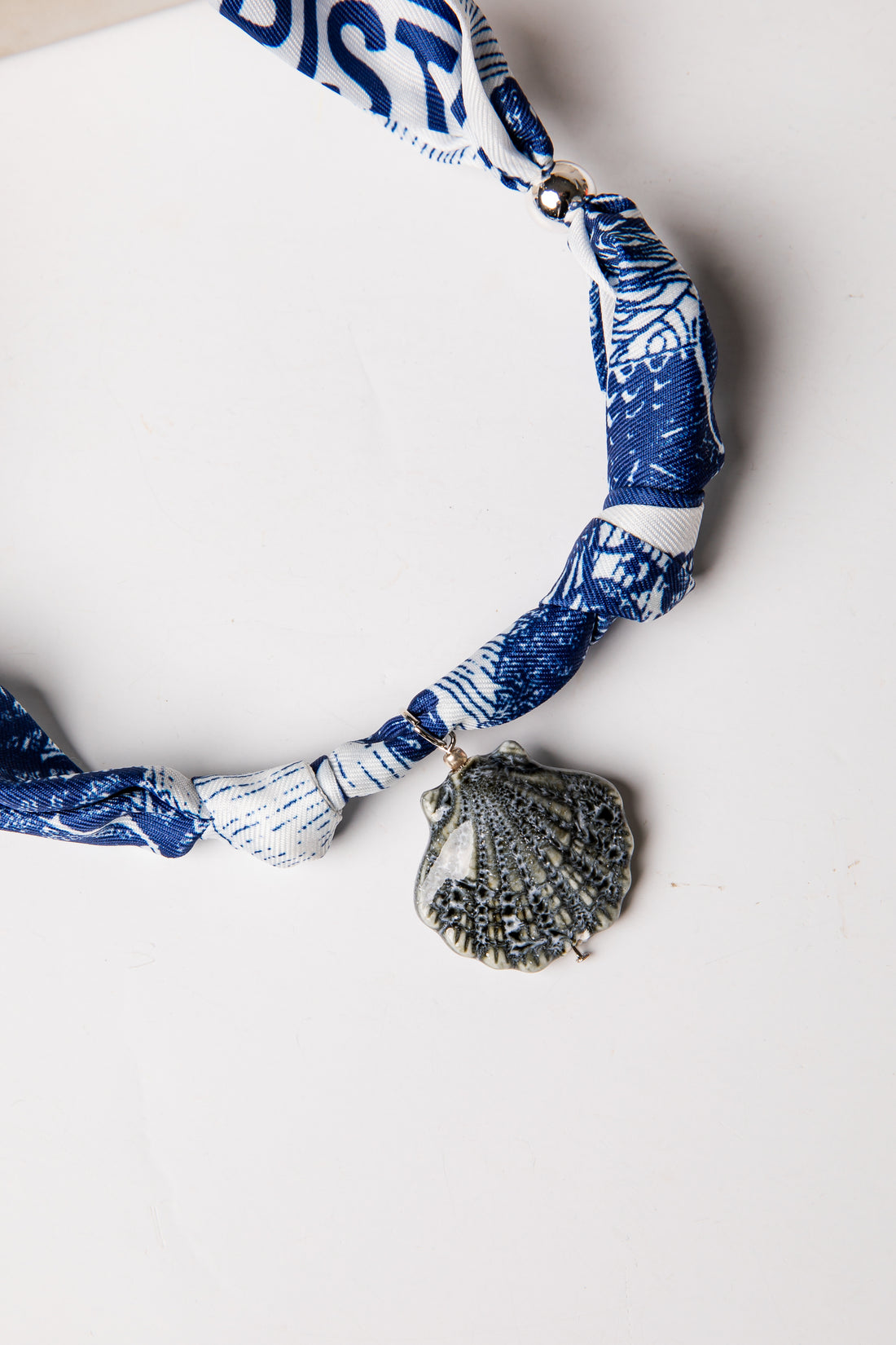 Necklace with shell pendant on a white background