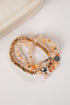 Set of beaded bracelets with gold and silver accents on a white surface
