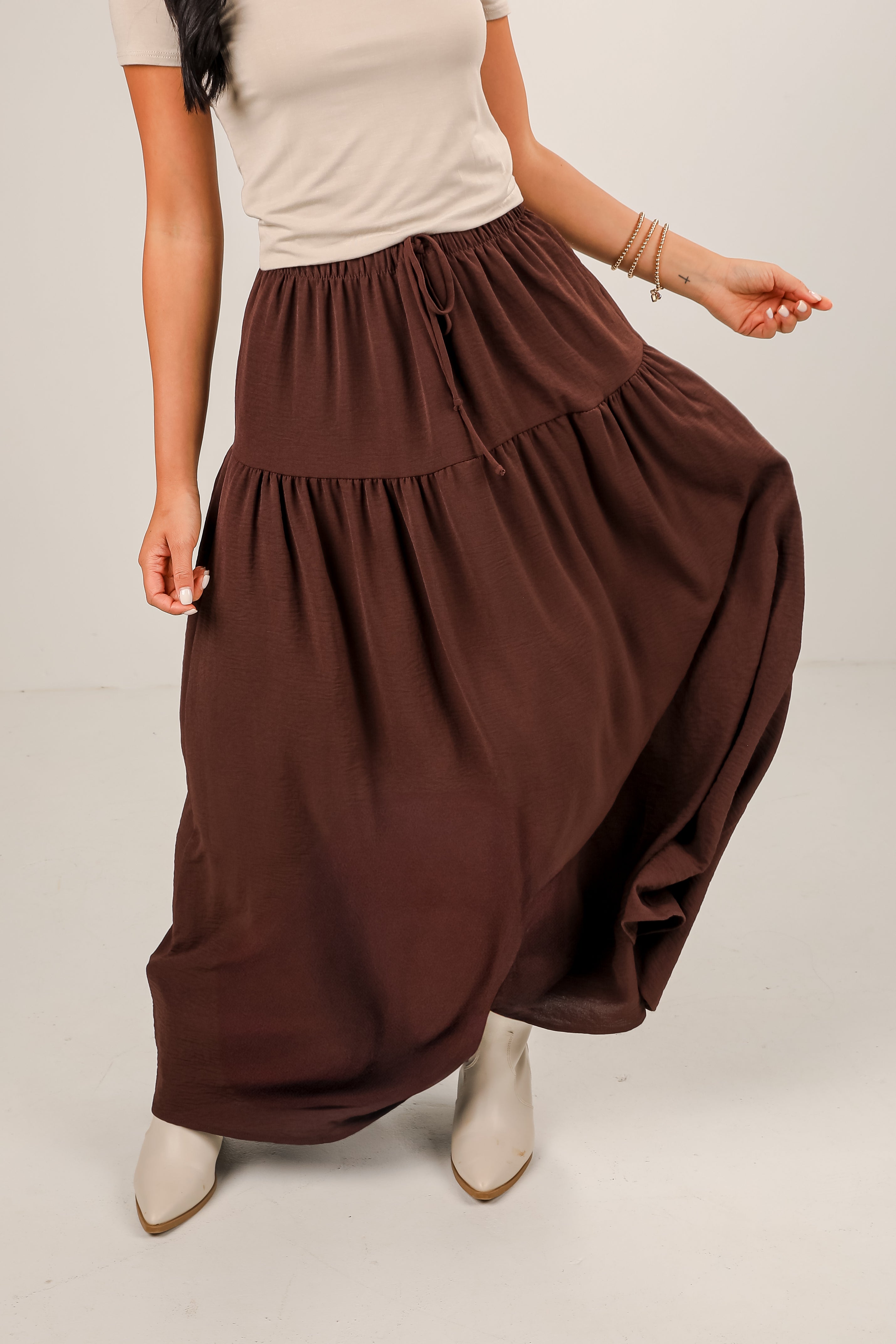 Brown maxi skirt worn by a person on a plain background