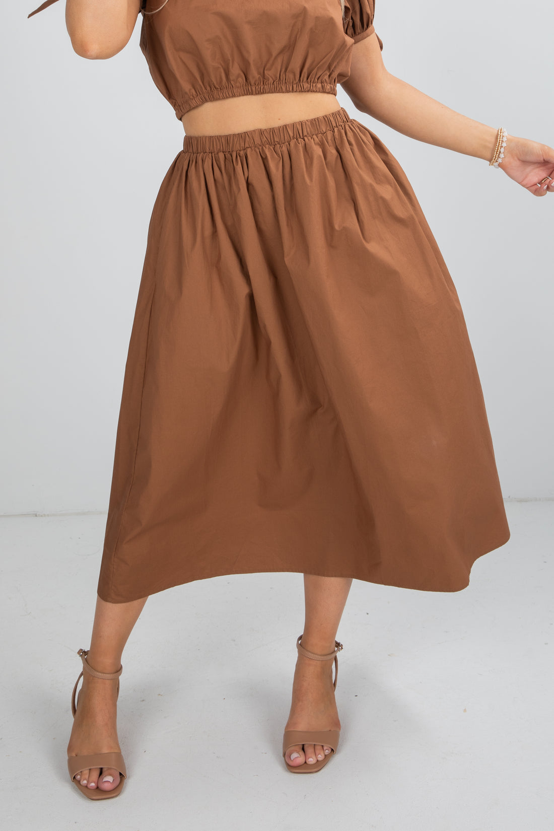 Brown dress worn by a person on a white background