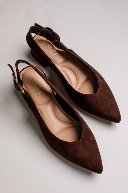 A pair of dark brown suede slingback flats with pointed toes and low block heels, displayed on a light gray background.
