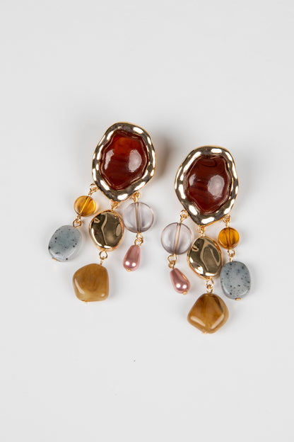 Pair of earrings with multicolored stones on a white background