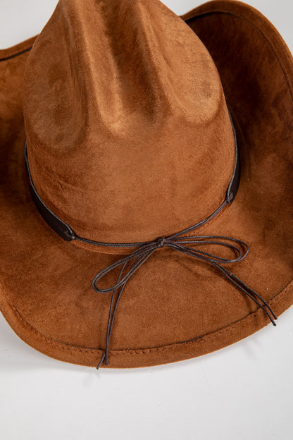 Brown suede hat with a leather band on a white background