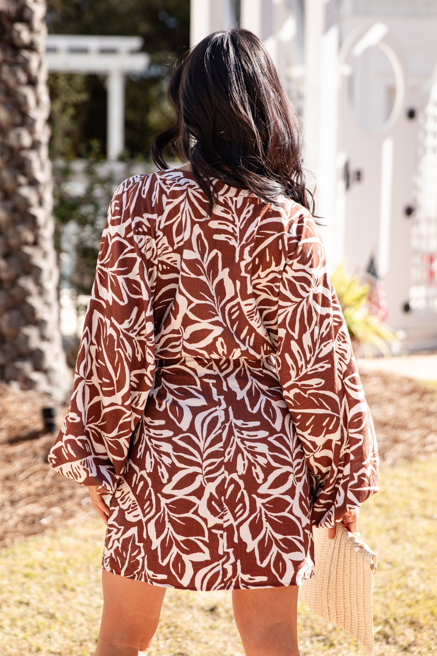 Woman wearing a patterned dress in an outdoor setting