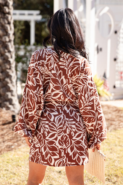 Woman wearing a patterned dress in an outdoor setting