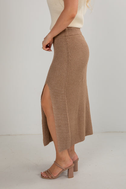 Brown ribbed skirt with a slit worn by a person on a white background