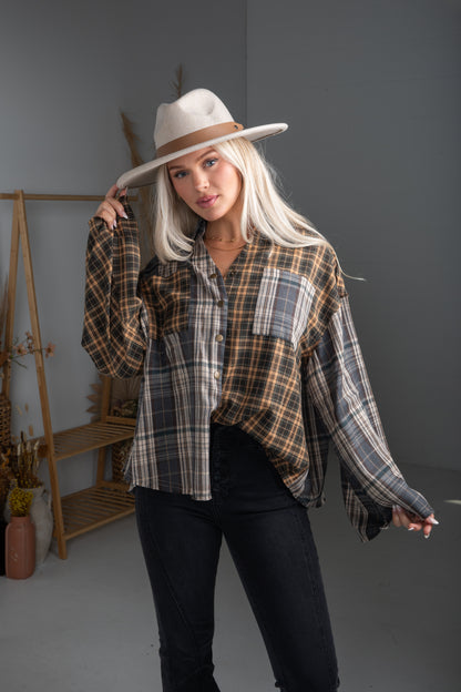 Woman wearing a plaid shirt and hat in a studio setting