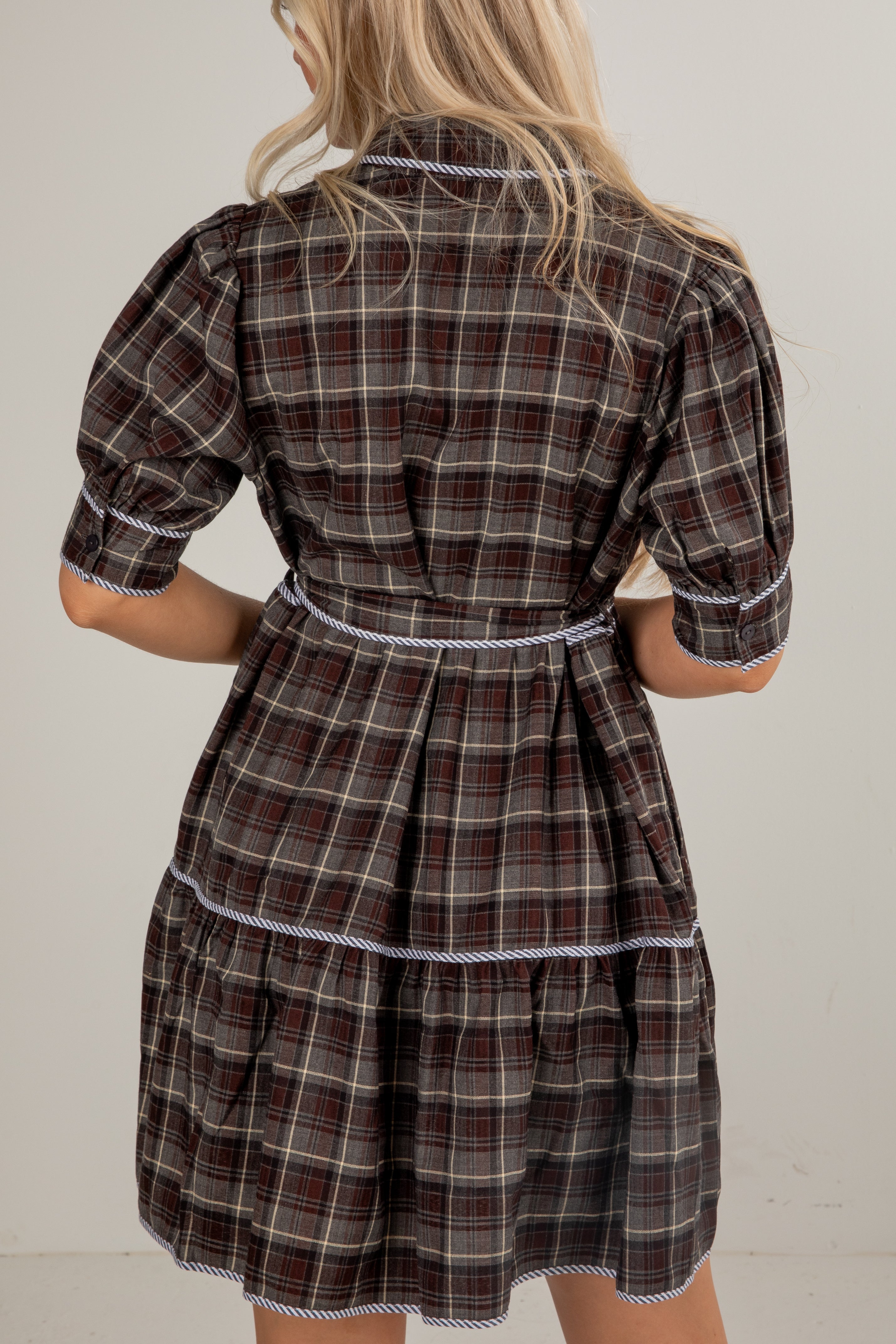 Plaid dress worn by a person against a plain background