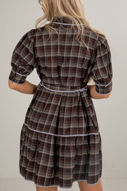 Plaid dress worn by a person against a plain background