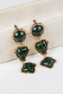 Green gemstone earrings with gold accents on a white background