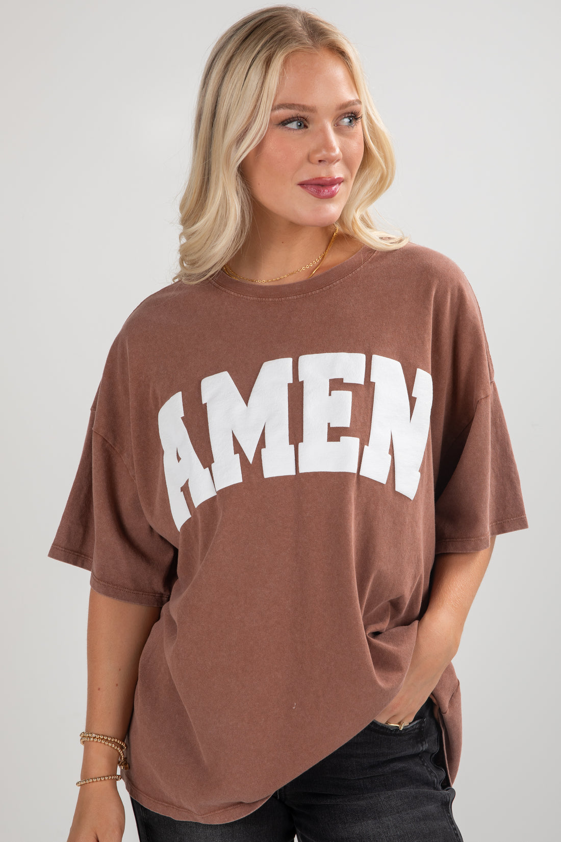 Woman wearing a brown t-shirt with &