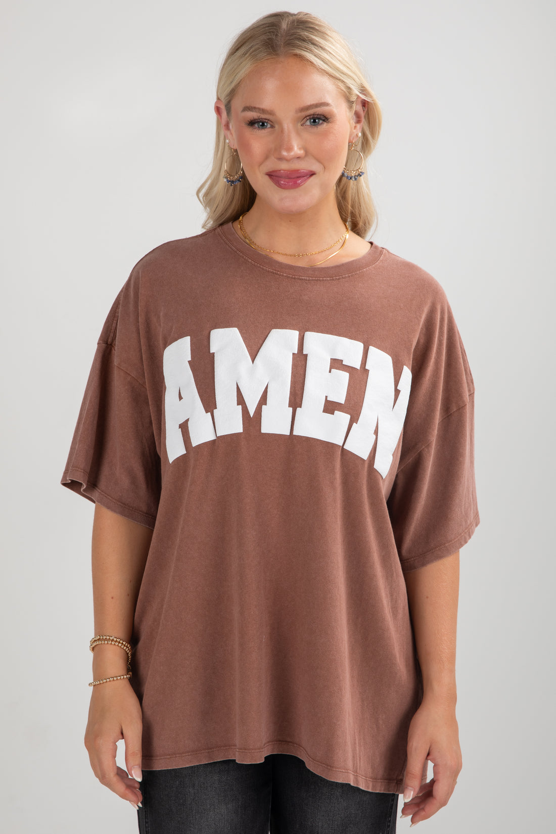 Woman wearing a brown t-shirt with &