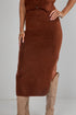 Brown knit dress with a slit on a plain background