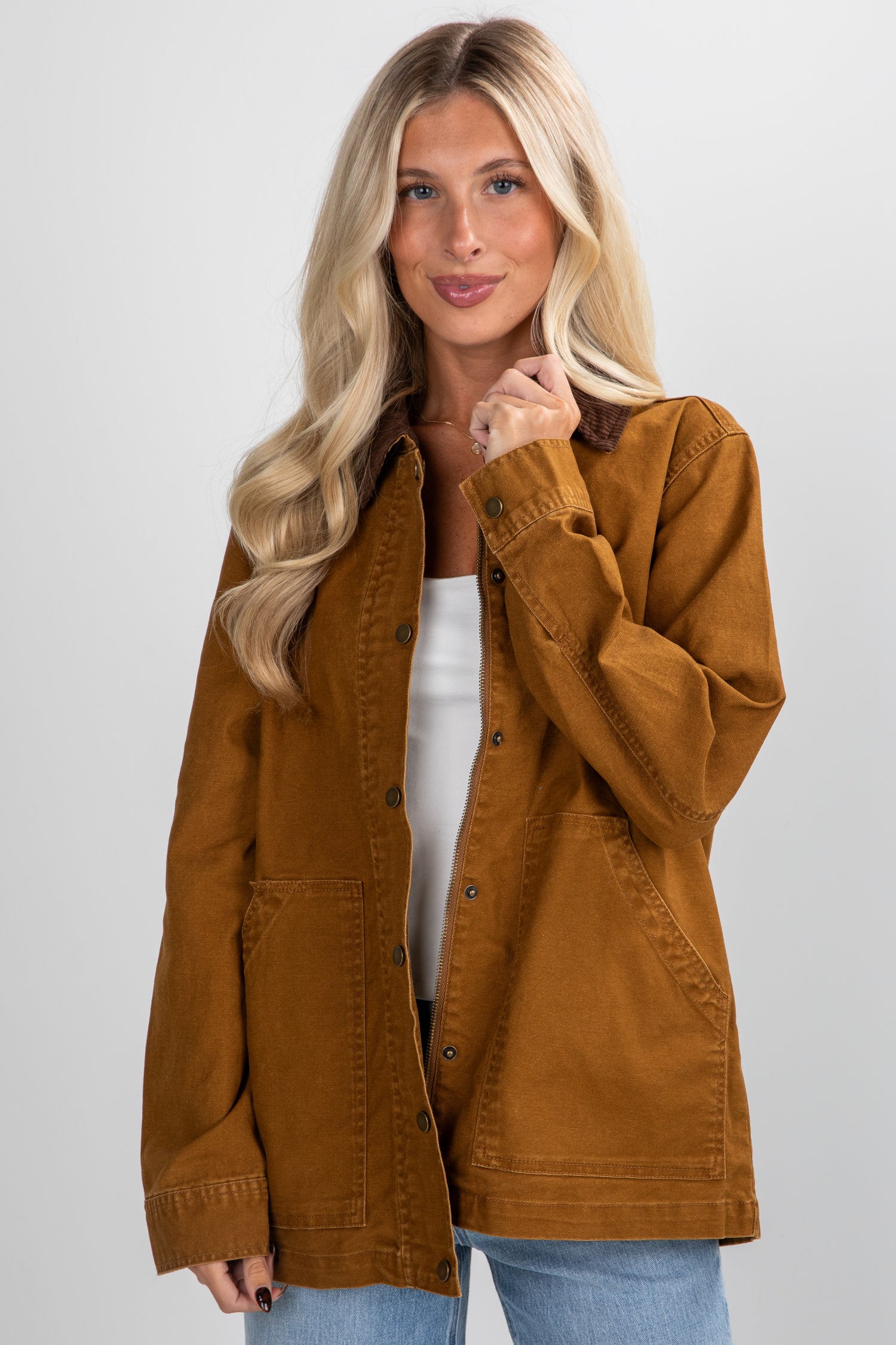 Woman wearing a brown jacket on a plain background