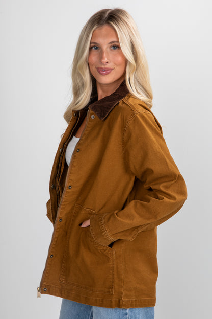 Woman wearing a brown jacket on a plain background