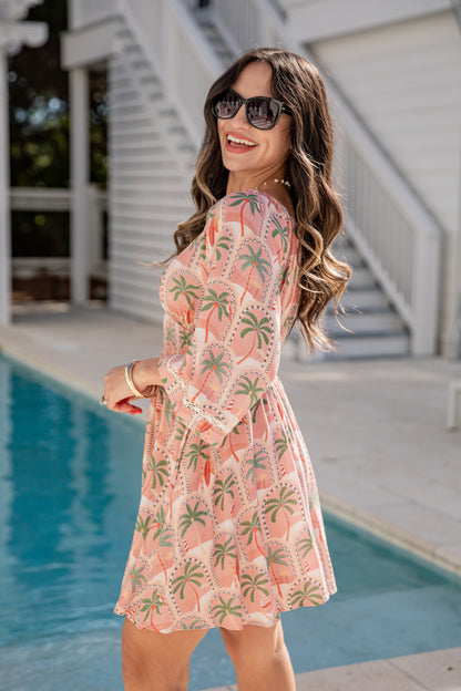 Woman in a floral dress standing by a pool