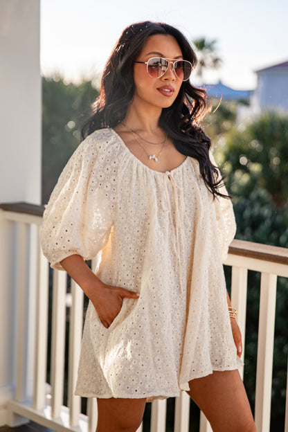 Woman wearing a white blouse with puff sleeves on a balcony