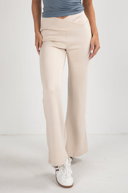 Beige pants worn by a person on a white background