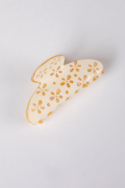 hair clip with floral patterns on a light gray background