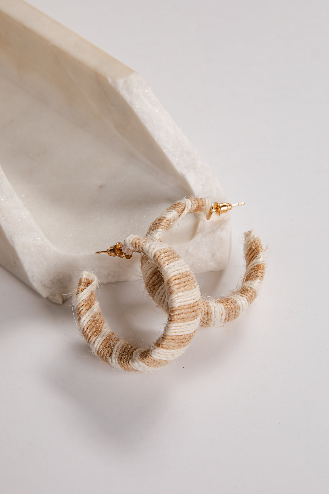 Pair of striped hoop earrings on a light background
