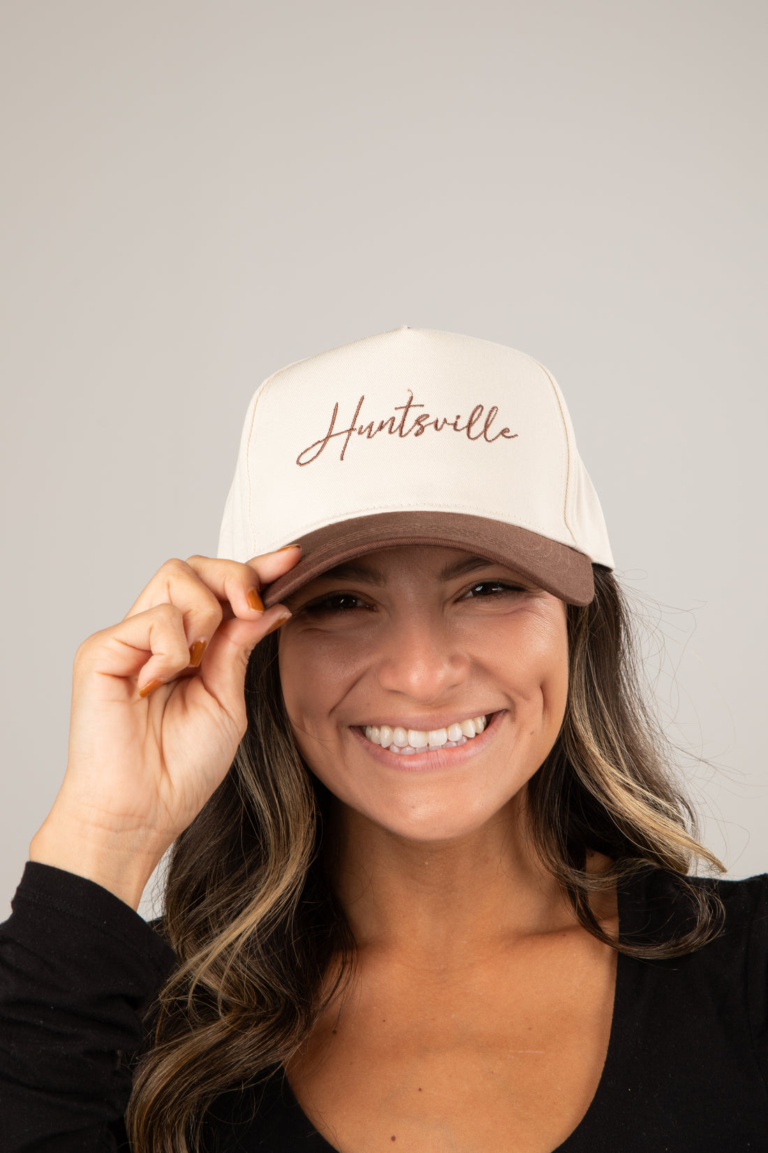 Woman wearing a white cap with &