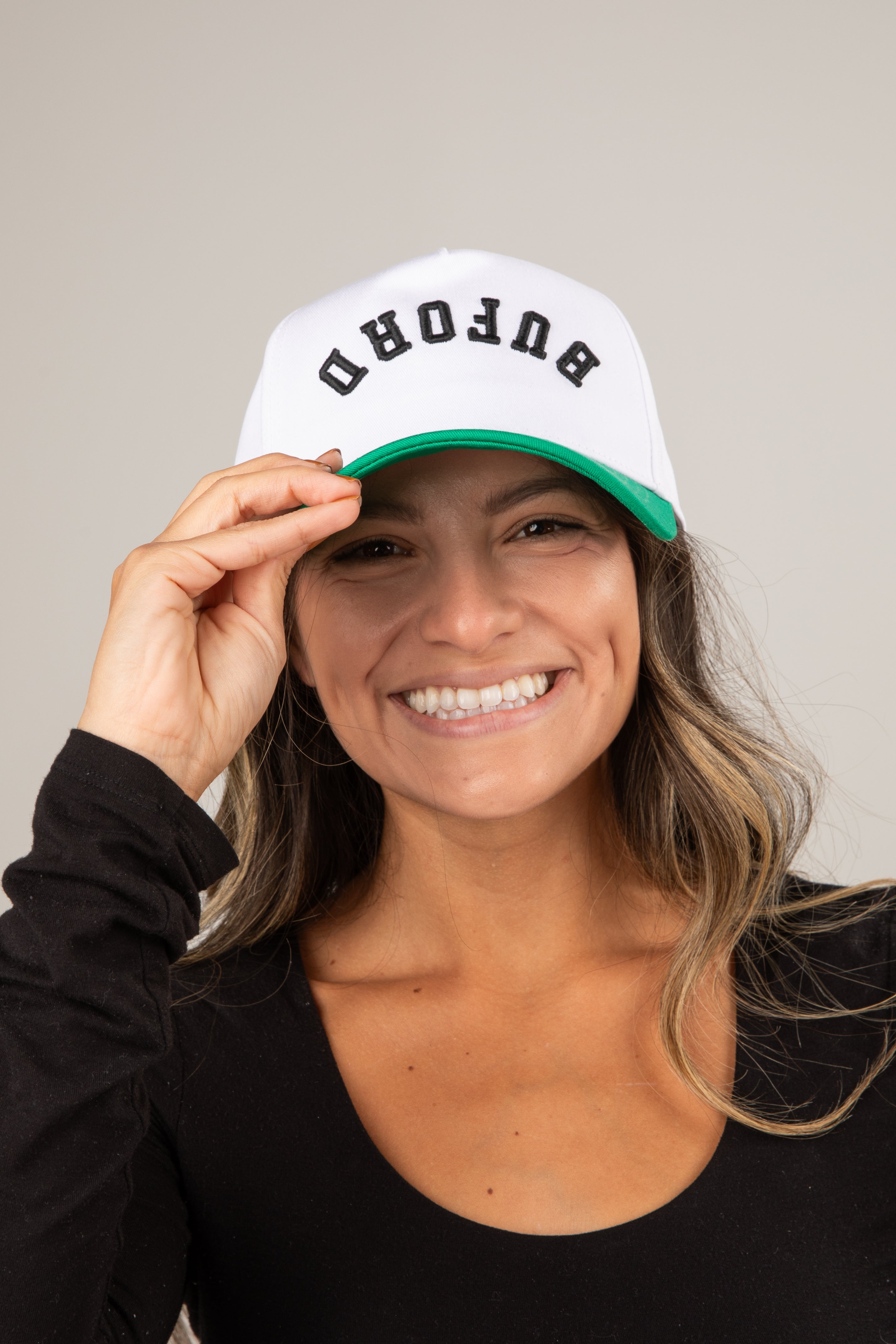 Woman wearing a white cap with &