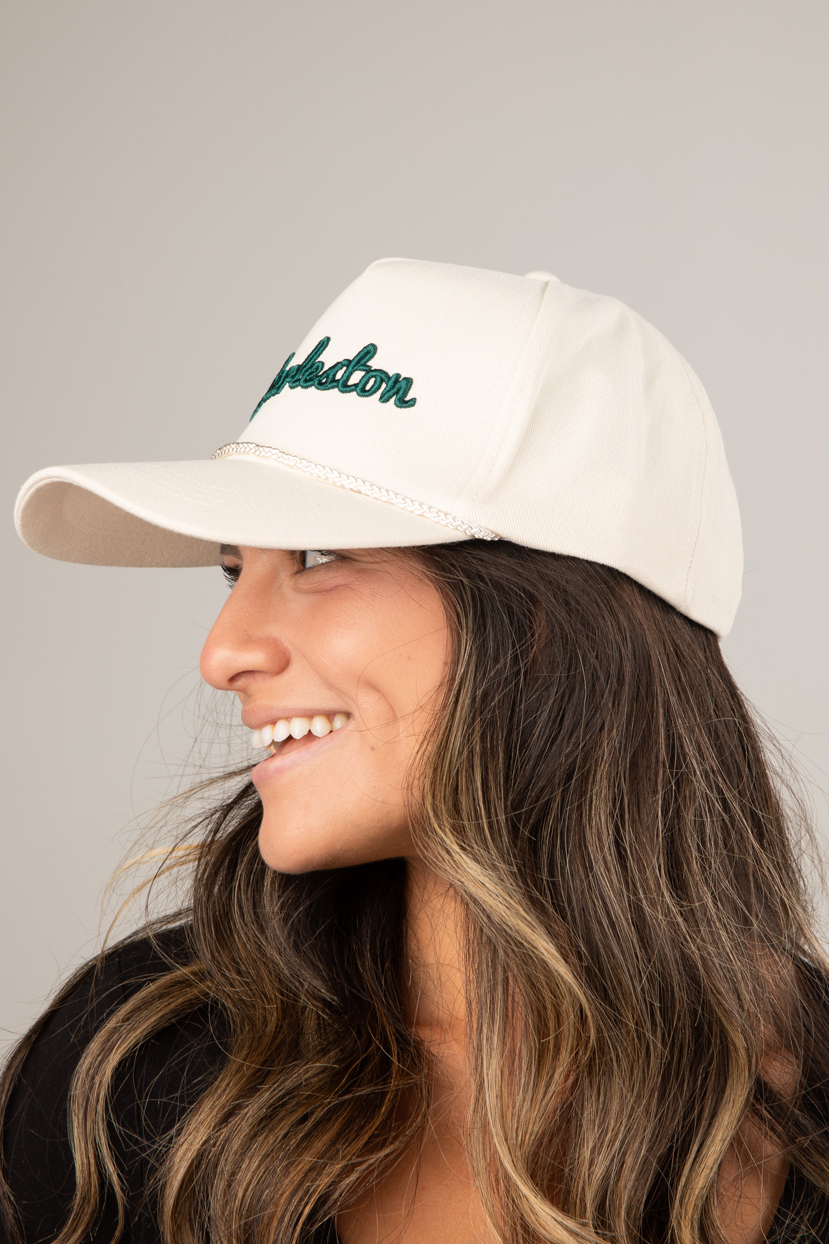 Woman wearing a beige cap with &