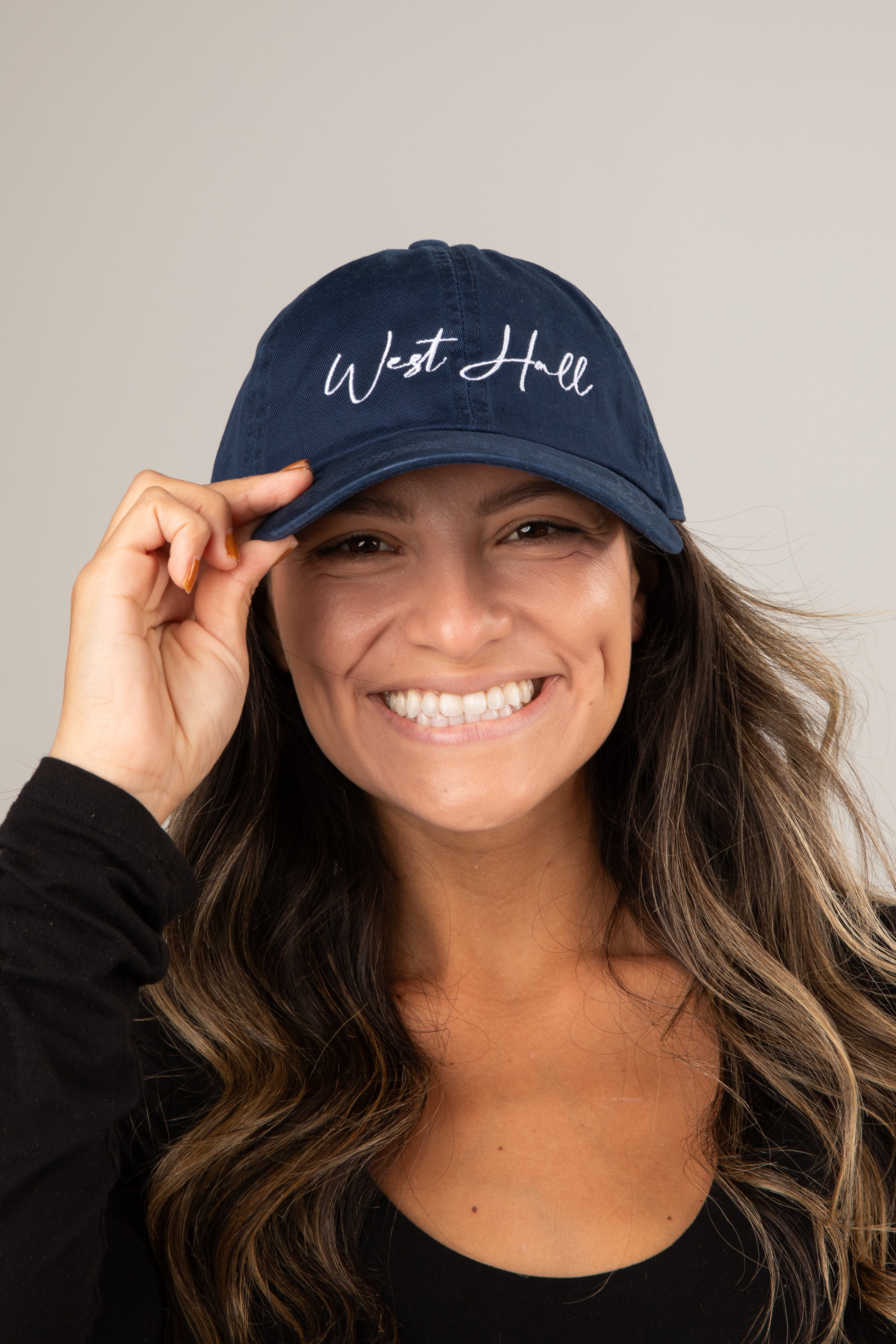 Woman wearing a navy blue cap with &