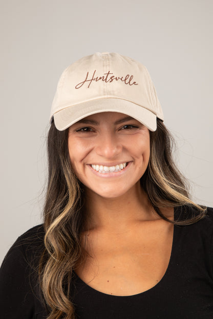 Woman wearing a beige cap with &