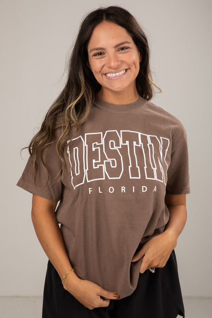 Woman wearing a brown t-shirt with &