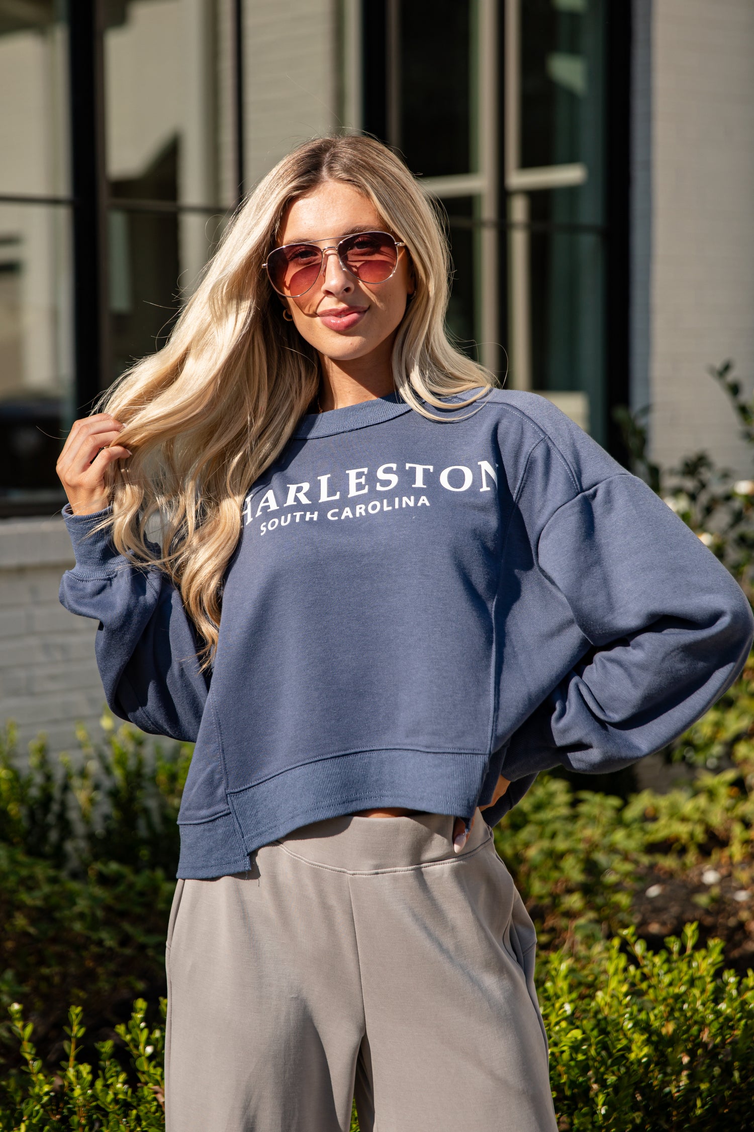 Woman wearing a blue sweatshirt with &