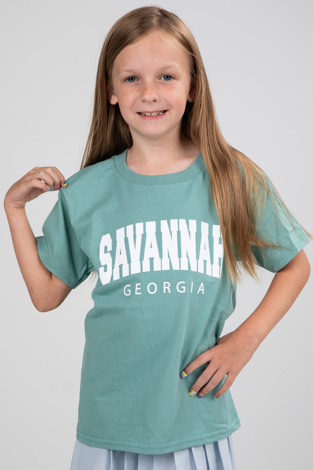 Girl wearing a teal t-shirt with &