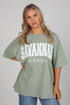 Woman wearing a green t-shirt with &