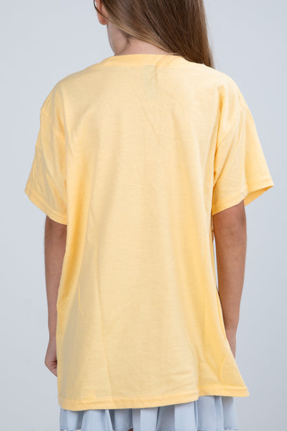 Person wearing a yellow t-shirt against a plain background