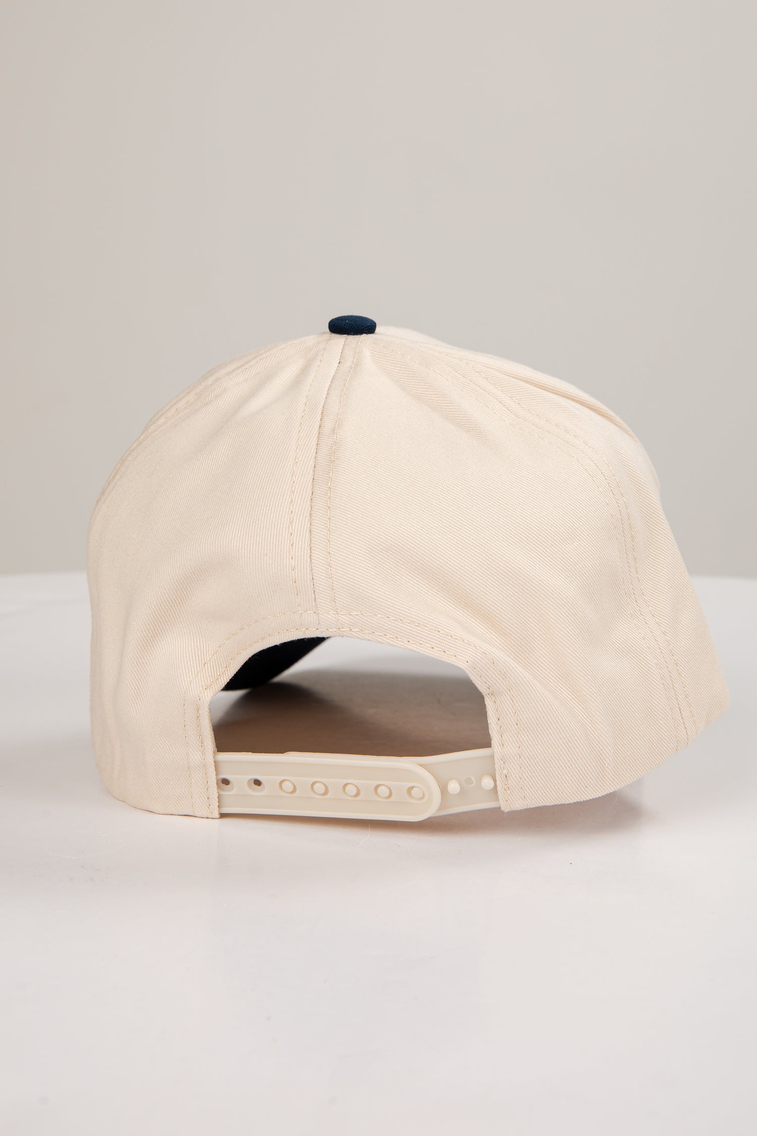 Beige baseball cap on a light gray background