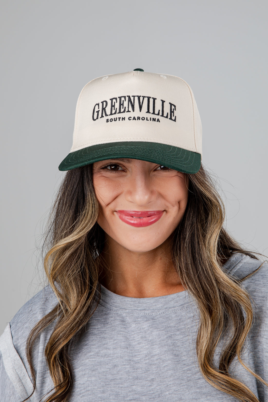 Woman wearing a cap with &