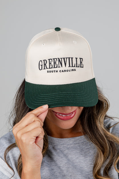 Person wearing a cap with &