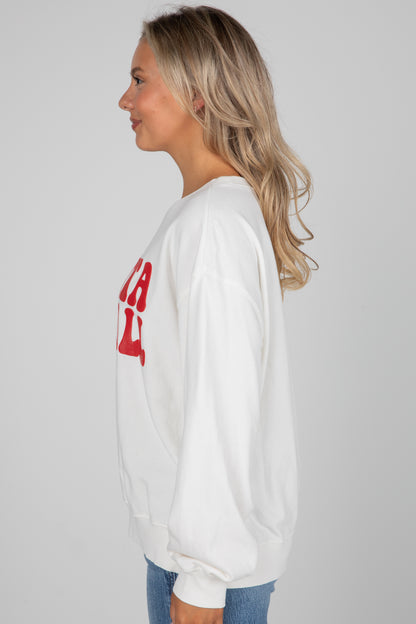 Woman wearing a white sweatshirt with red text on a plain background