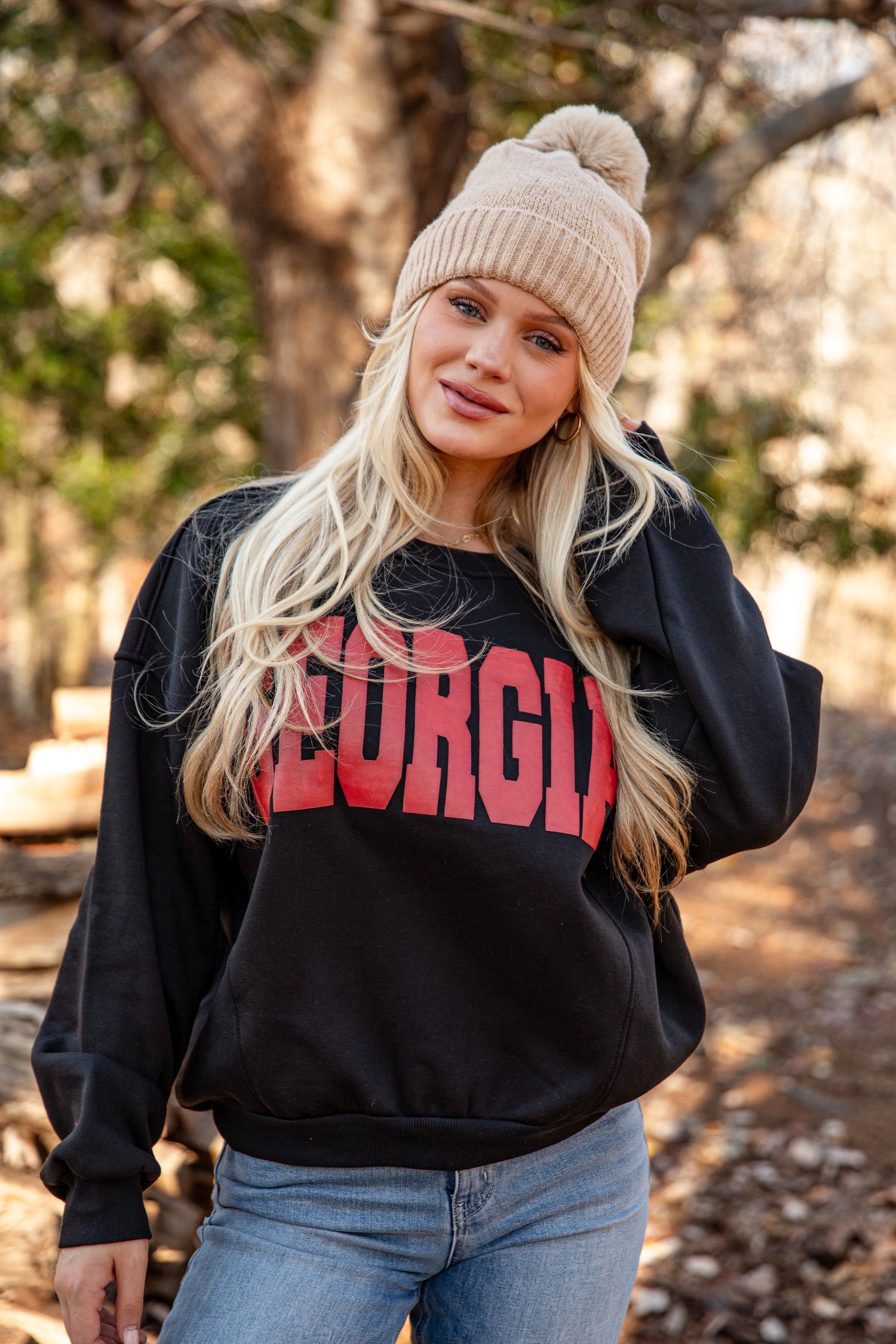 Person wearing a black sweatshirt with &