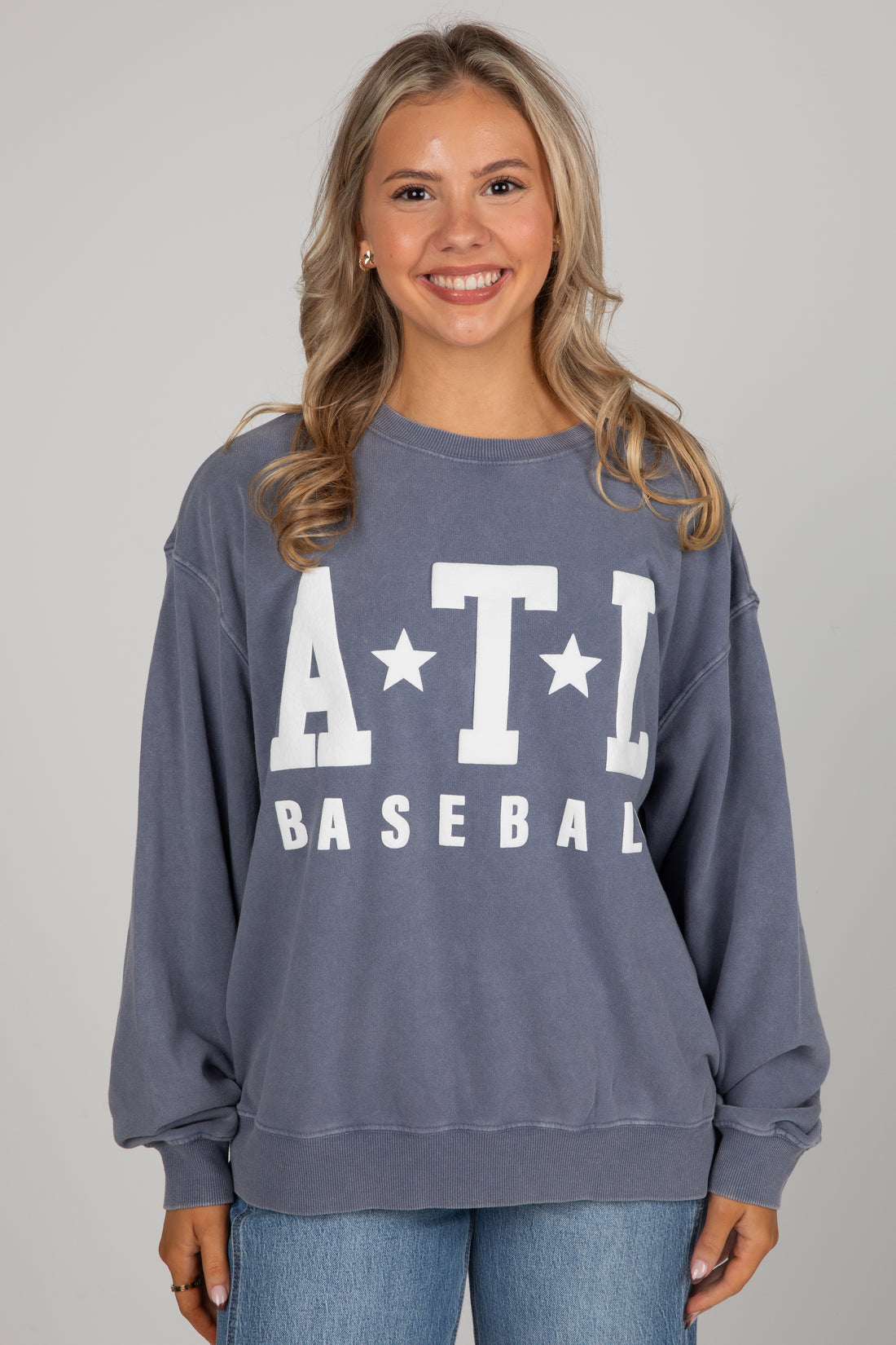 Woman wearing a blue sweatshirt with &