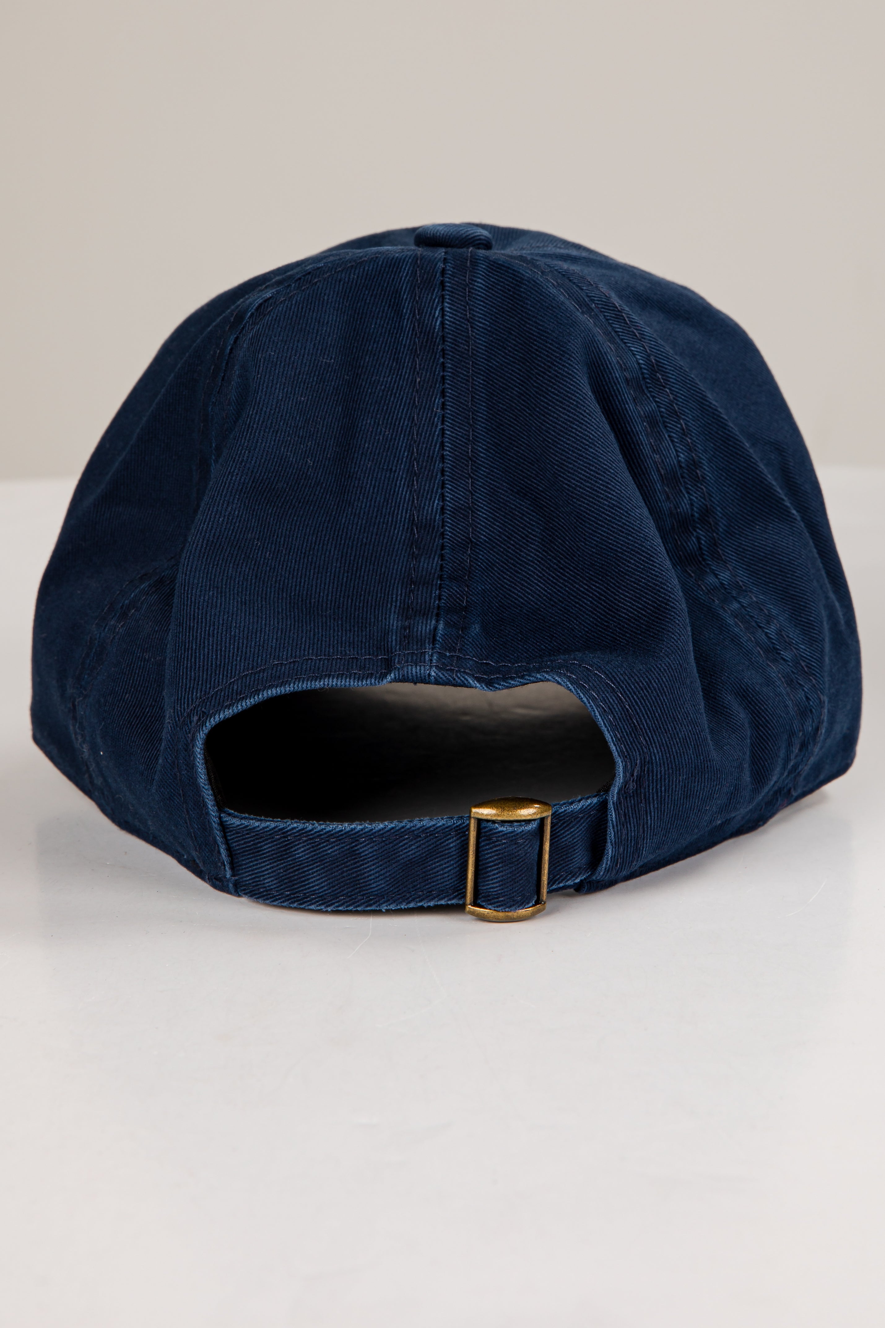 Navy blue baseball cap on a light gray background