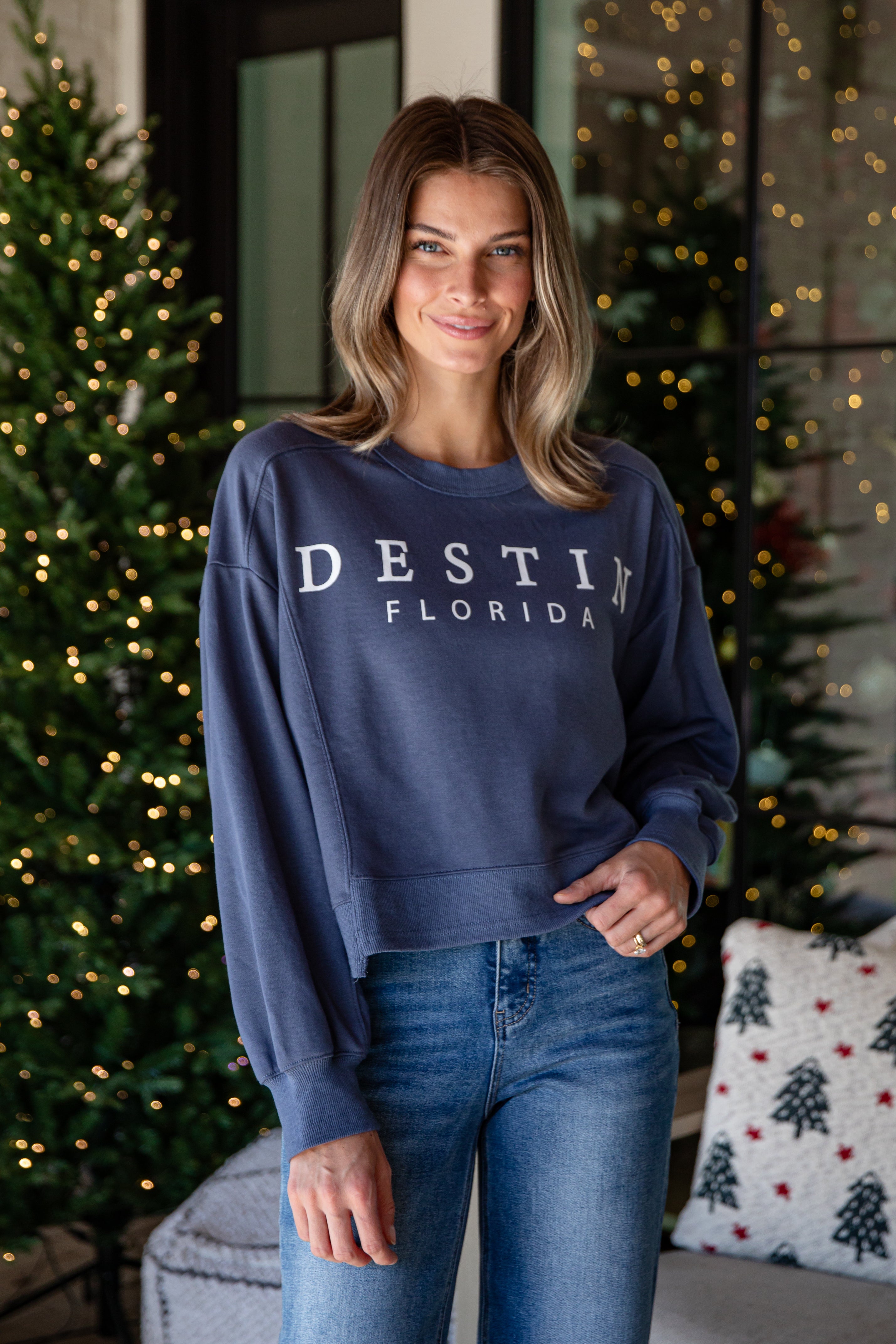 Woman wearing a navy blue sweatshirt with &