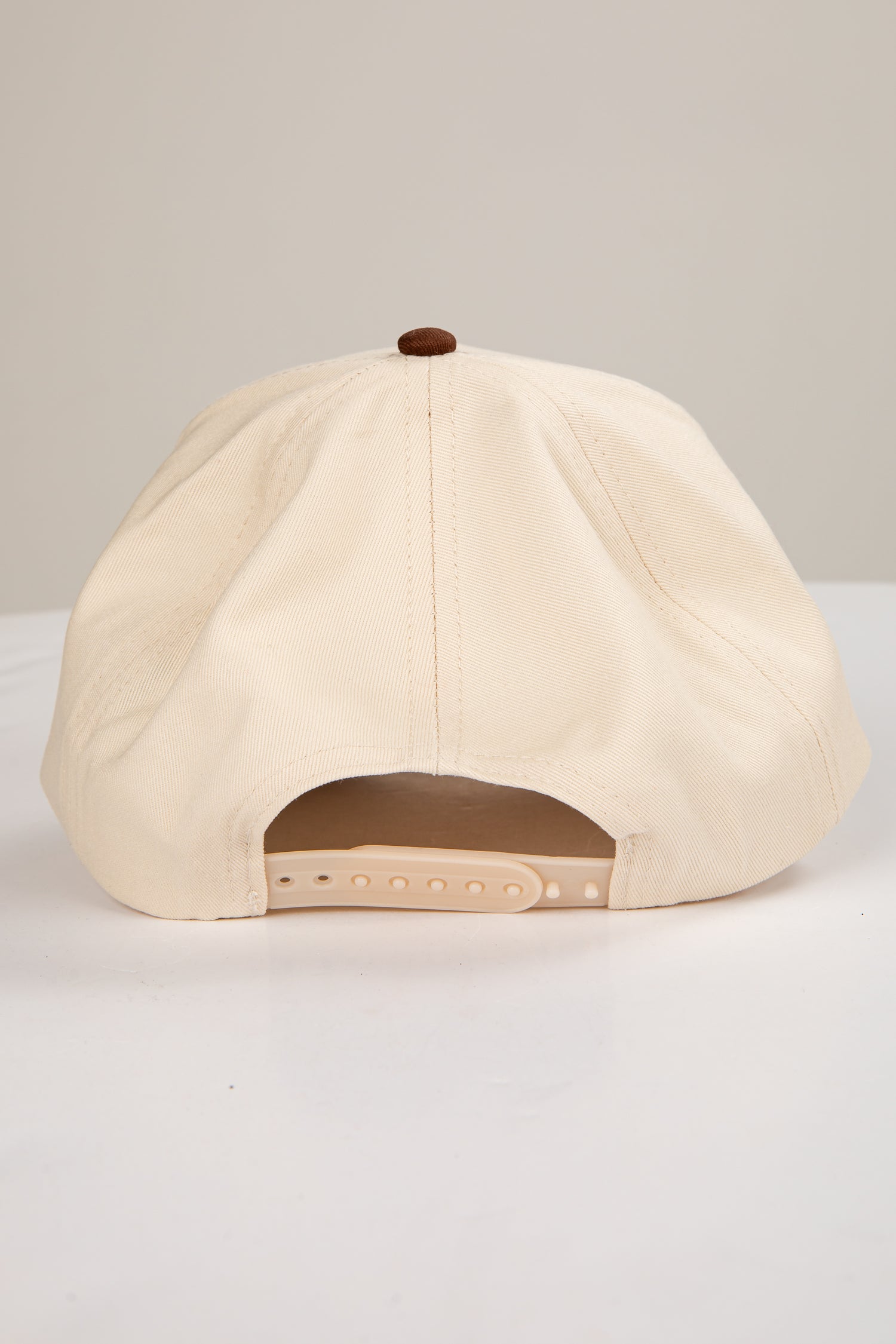 Beige baseball cap on a light gray background