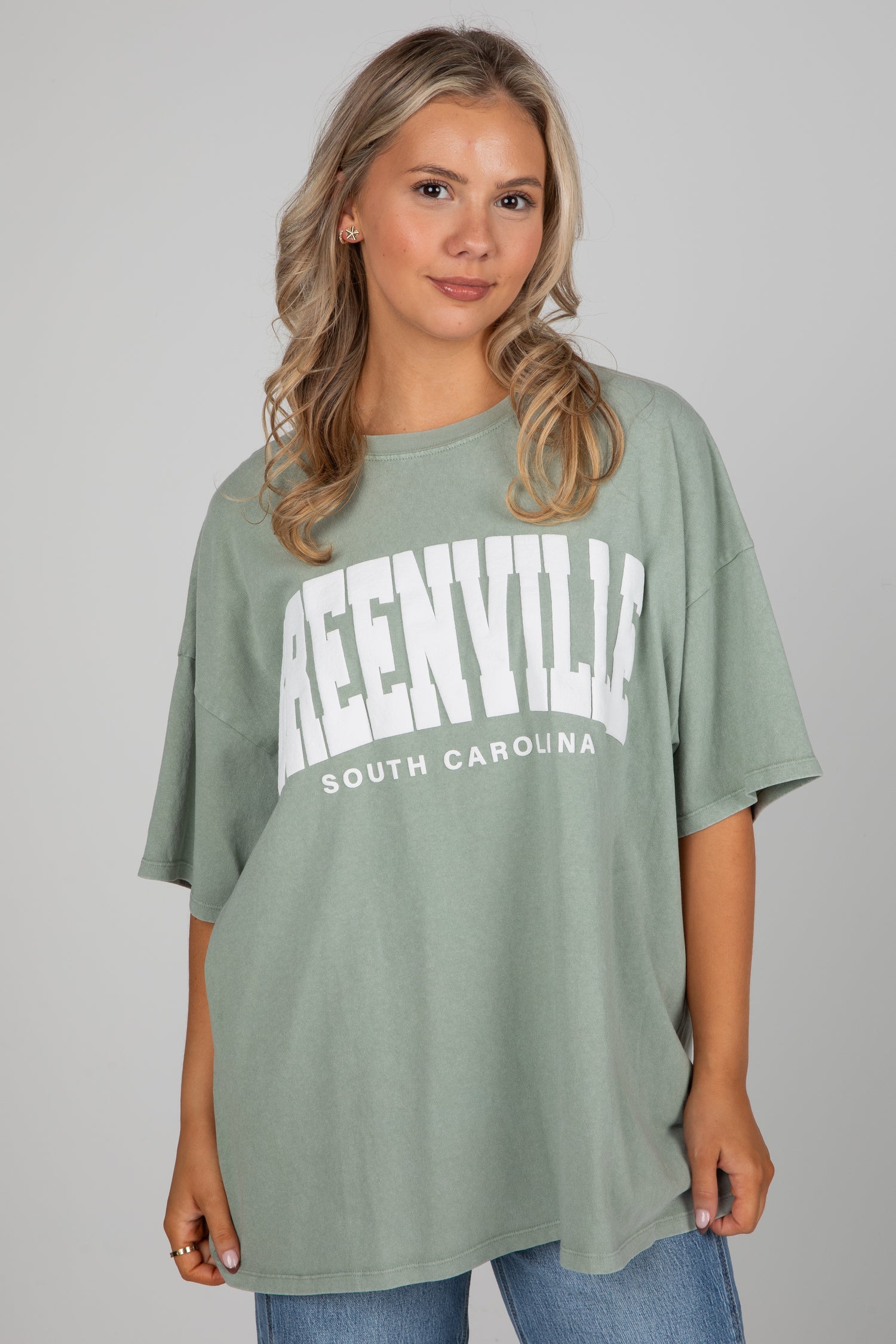 Woman wearing a green t-shirt with &