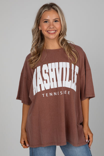 Woman wearing a brown t-shirt with &