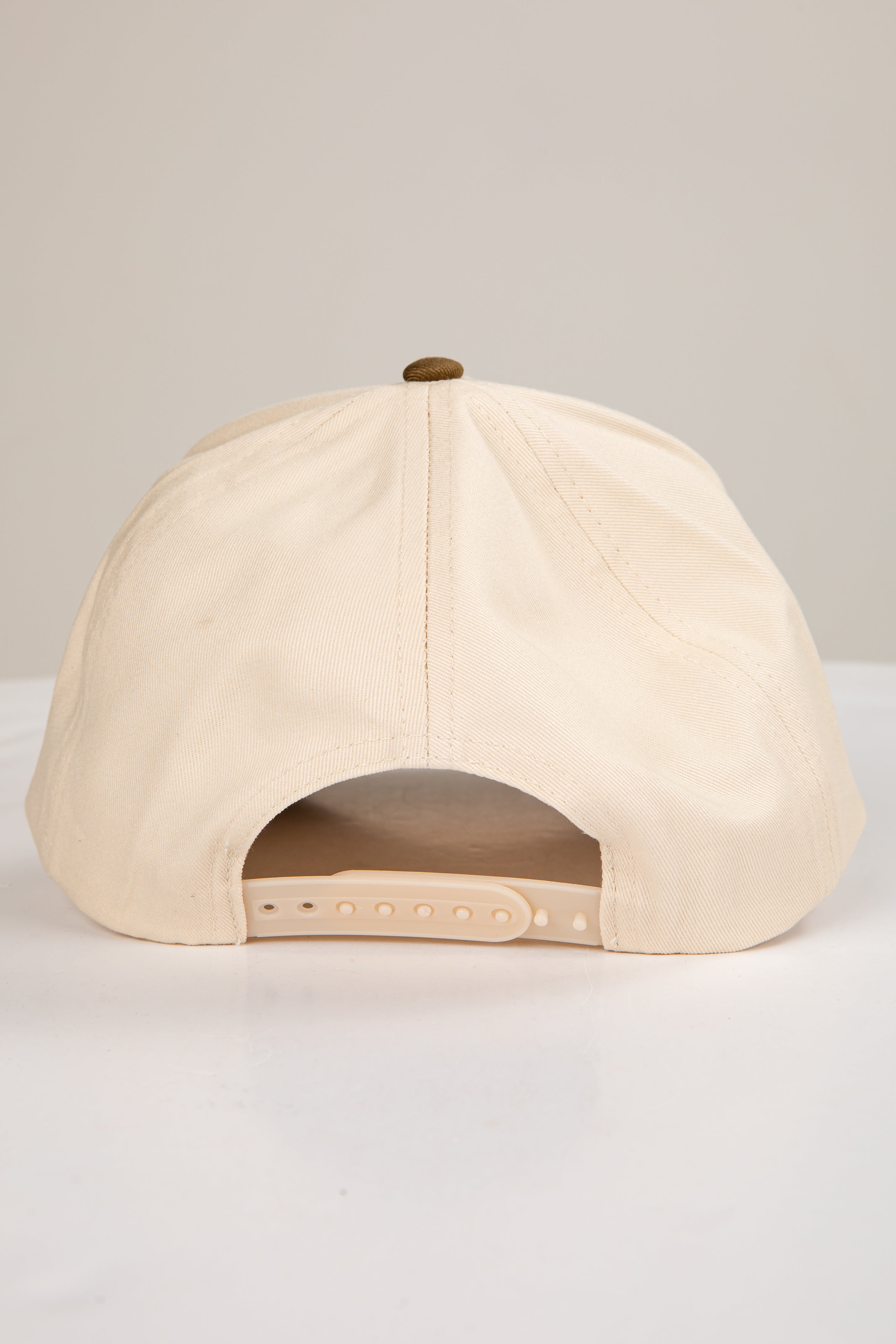 Beige baseball cap on a light gray background