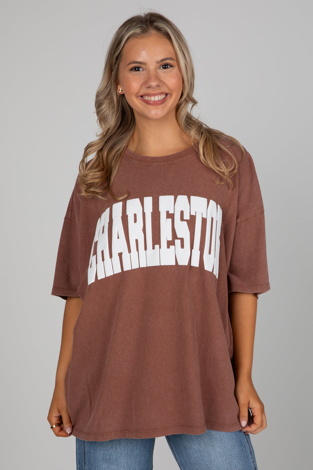 Woman wearing a brown t-shirt with &